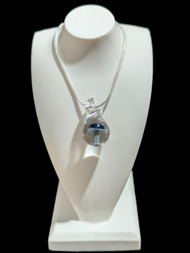 Blue mushroom in clear glass pendant on a white bust